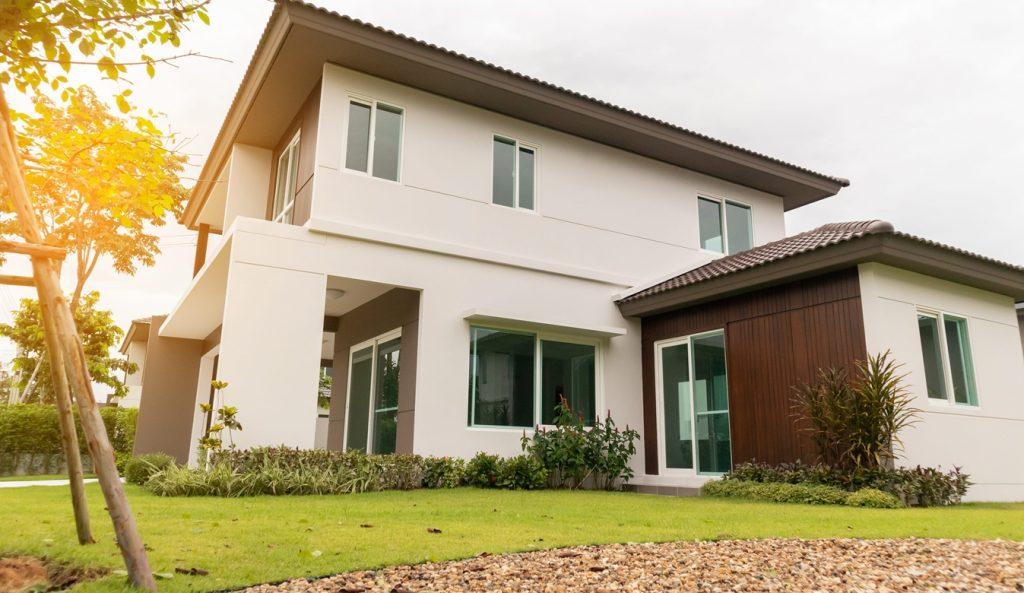 Beautiful modern house exterior with green grass