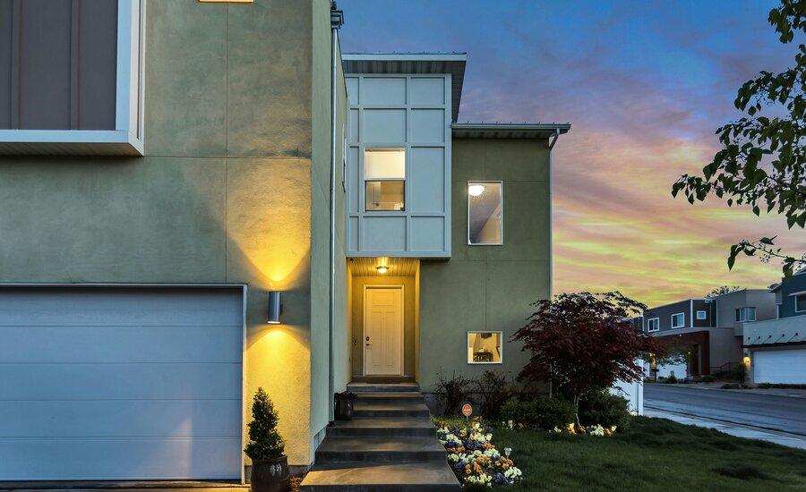 House exterior with outdoor lamps turned on at dusk