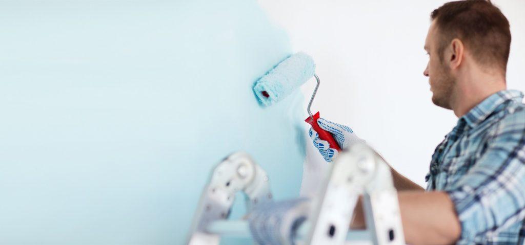 Painter in gloves holding painting roller