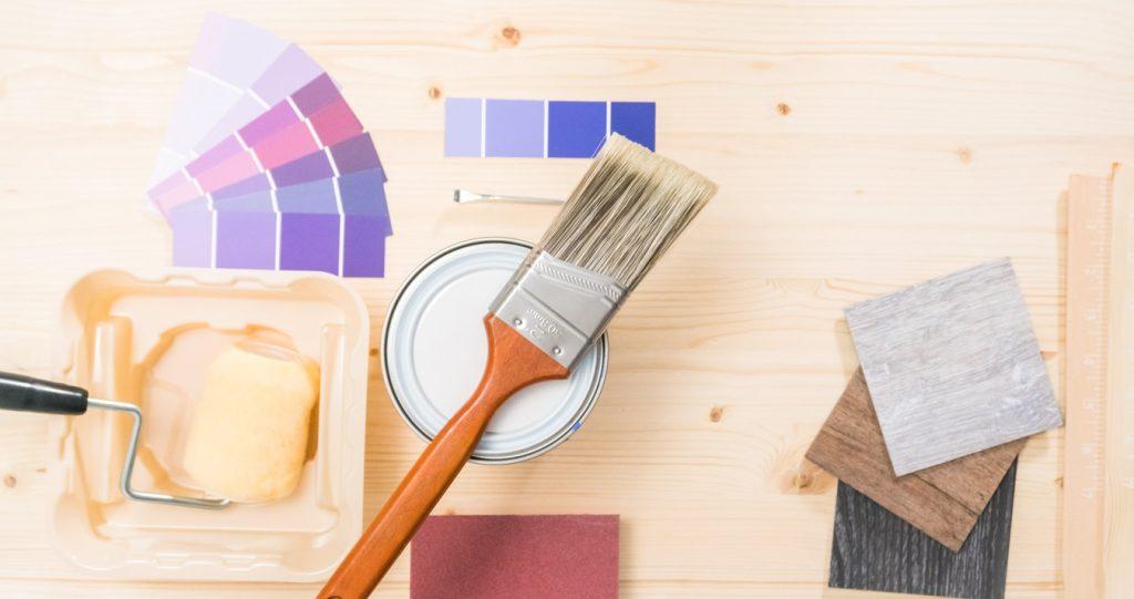 Purple paint and paint brushes for home improvement project