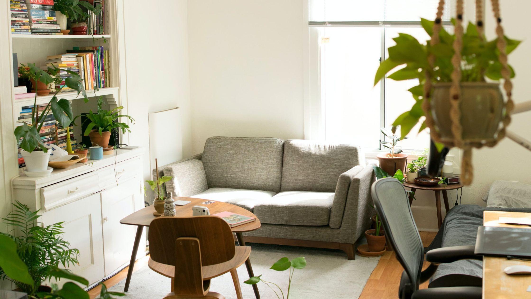 Gray fabric loveseat near brown wooden table