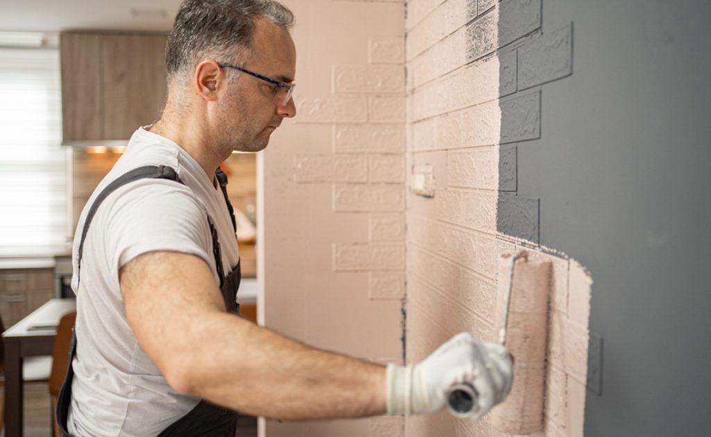 Man working on a brick wall