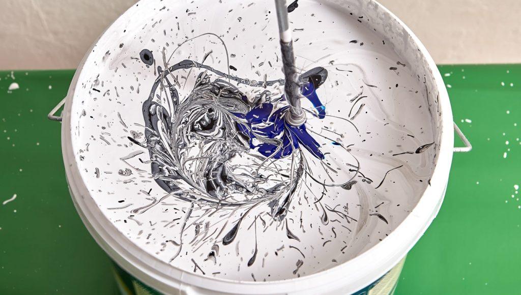 Mixing different colour paint together for painting walls in cosmetic renovations
