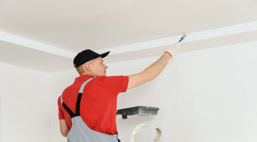 Painting the ceiling and painter uses paintbrush