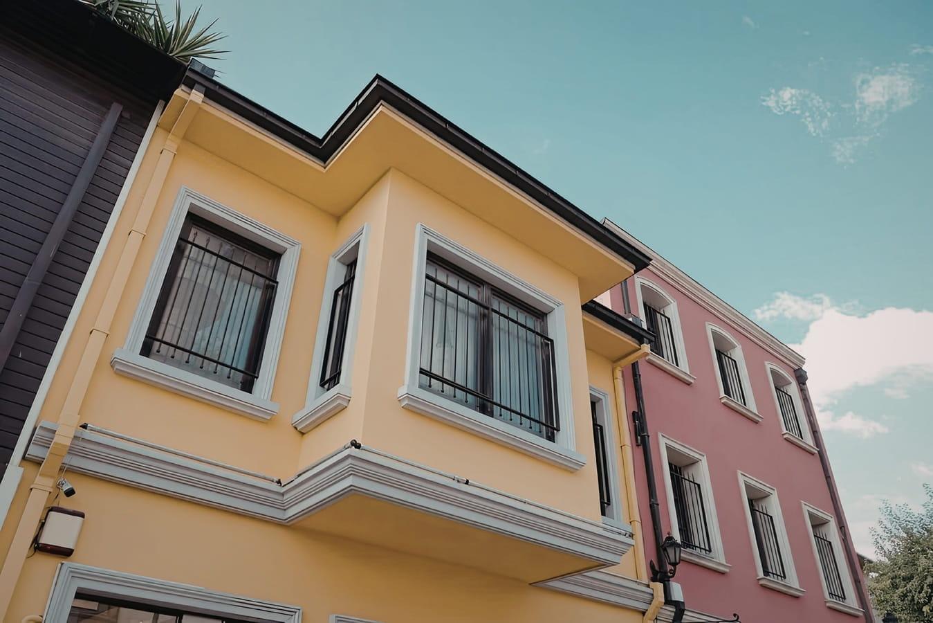 Twostory building with a yellow and pink facade