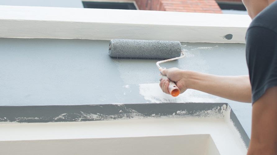 Using paint roller for paint building wall